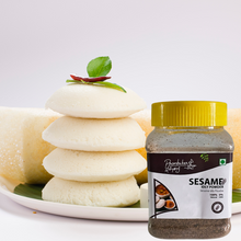 Charger l&#39;image dans la galerie, container of Sesame Idly powder behind a Plate of Idly home made-Poombukar
